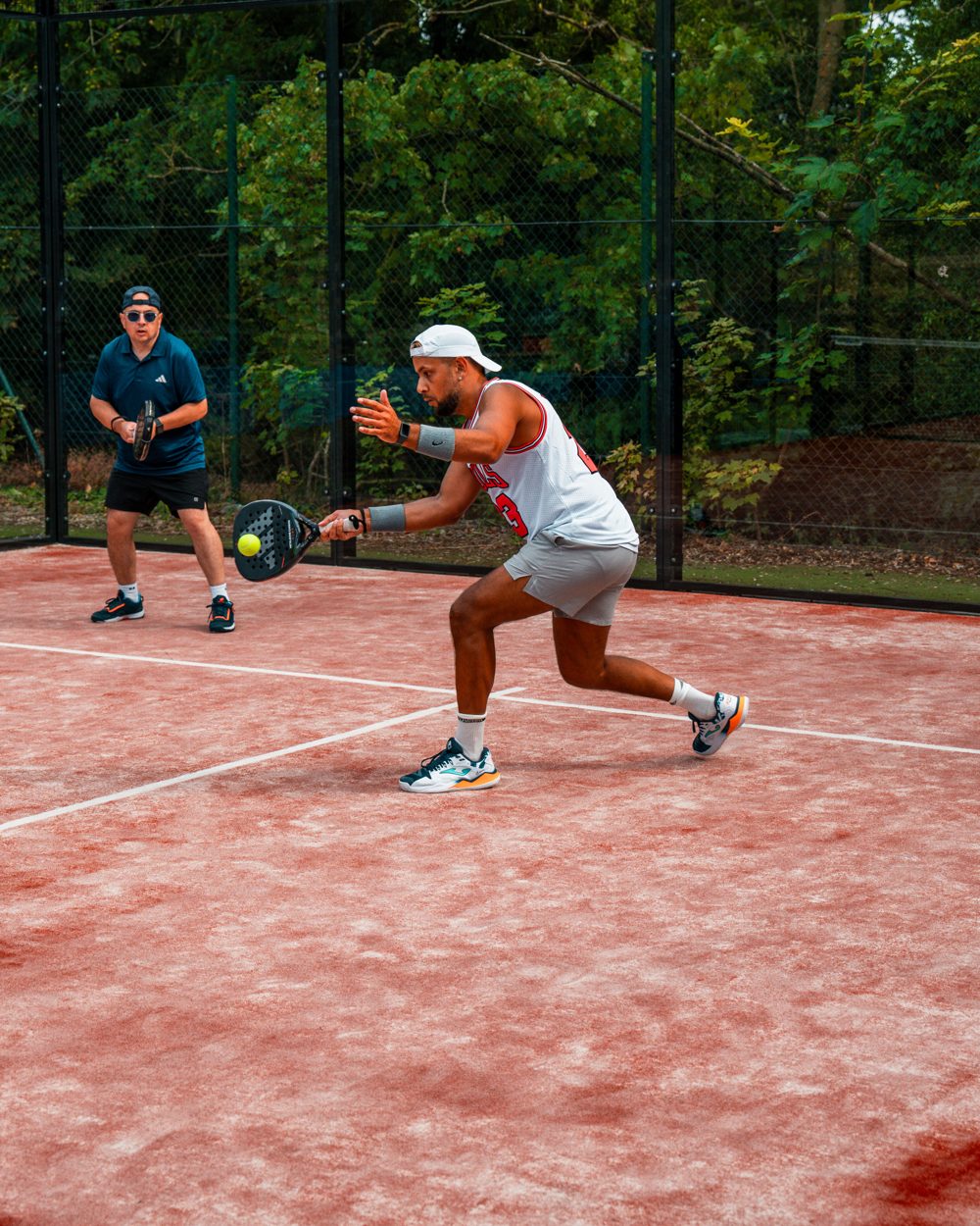 Doubles padel rally during a Mexicano social session